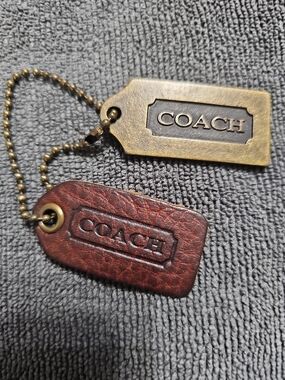 "Vintage Coach Mahogany Leatherwear" and "Raised Letter Solid Brass Plaque Fob."